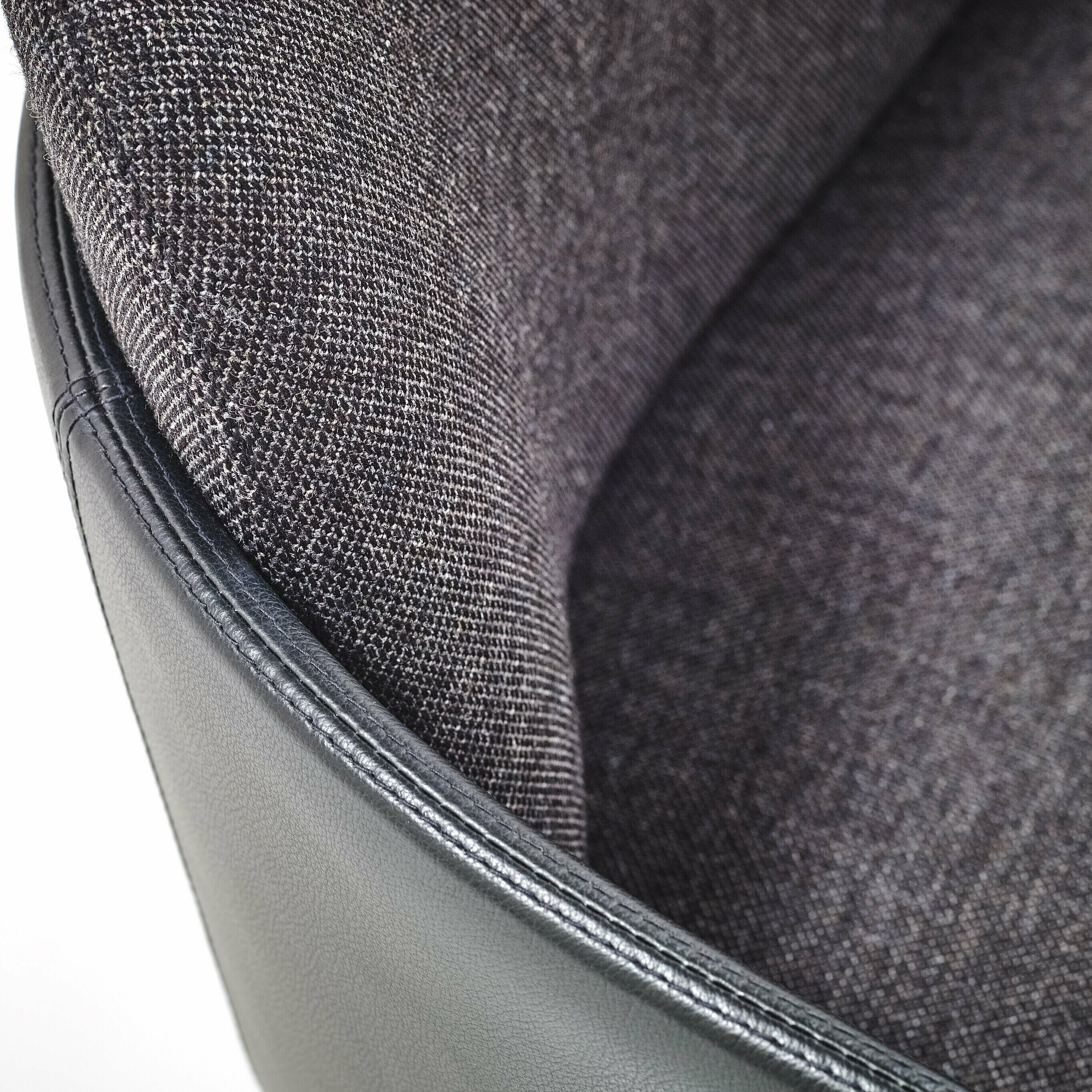 Merwyn Dining Sofa Detail with black armrest shell and backrest in a dark gray fabric