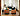 Vuelta Lounge Island Sofas mit grünem Samt bezogen hinter zwei cognacfarbene Leder Kubus Fauteuils und weißem Vuelta 80 Fauteuil und DD Table Beistelltisch mit Marmorplatte