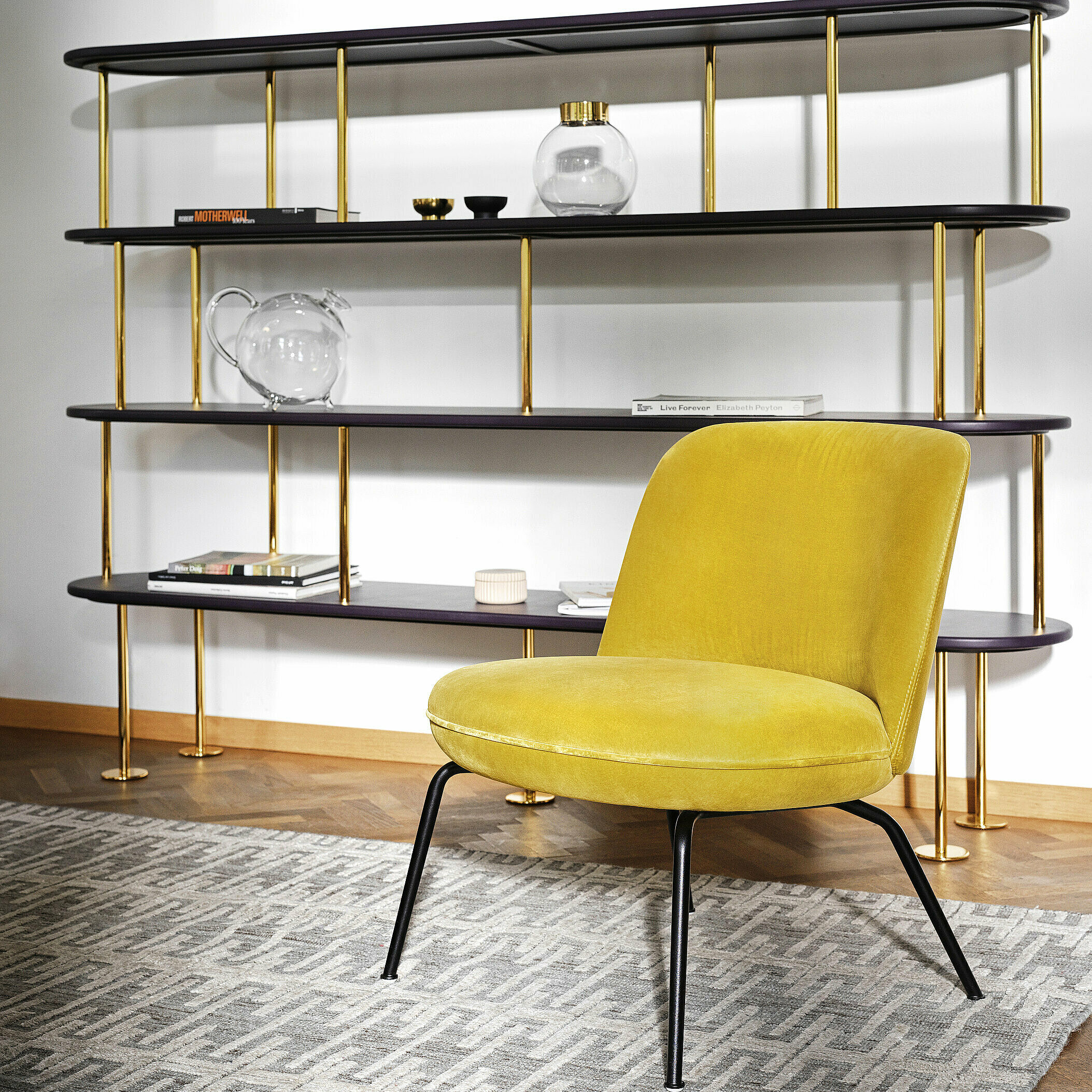 Merwyn Lounge Chair in velvet gold in front of MD Shelf with golden parts