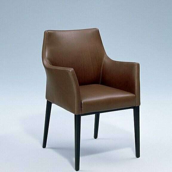 Toga chair covered with brown leather with armrests