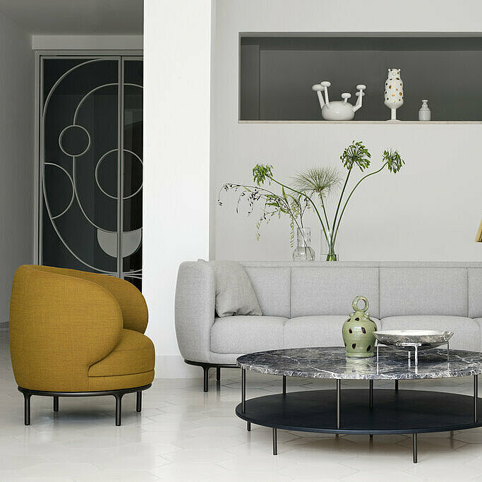 mustard-colored Vuelta72 armchair, light gray Vuelta sofa, Vuelta high-back chair, two DDTable with marble tops
