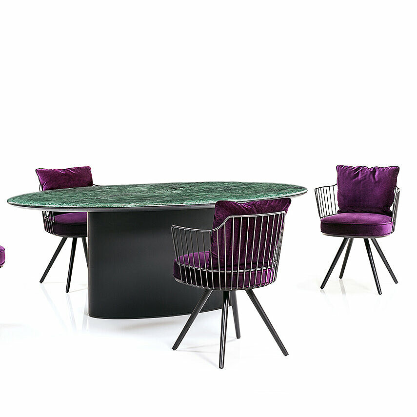 Paradise Bird Dining chair group in purple fabric upholstery and black frame to an Antilles Dining Table 