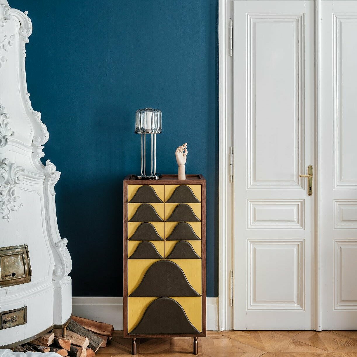 medium Antigua cabinet in yellow with brown leather handles and acacia table lamp in front of blue wall