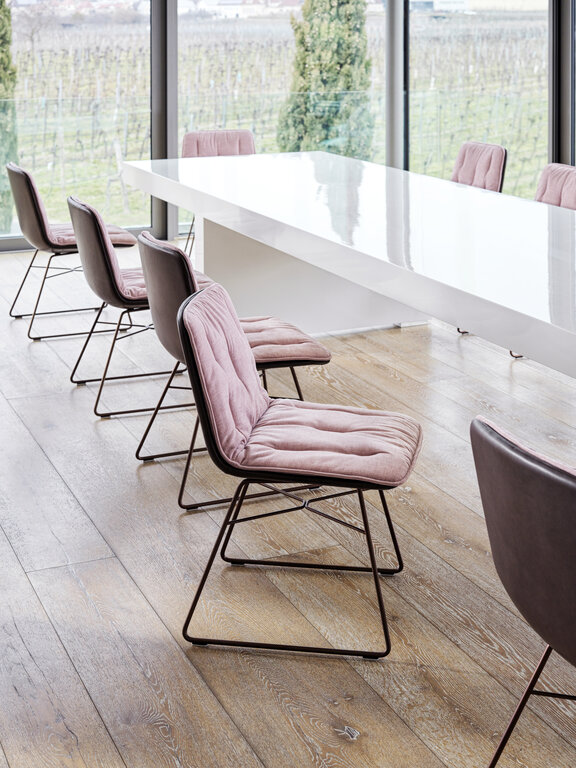 Shilo chairs with pink seat pad in front of white meeting table